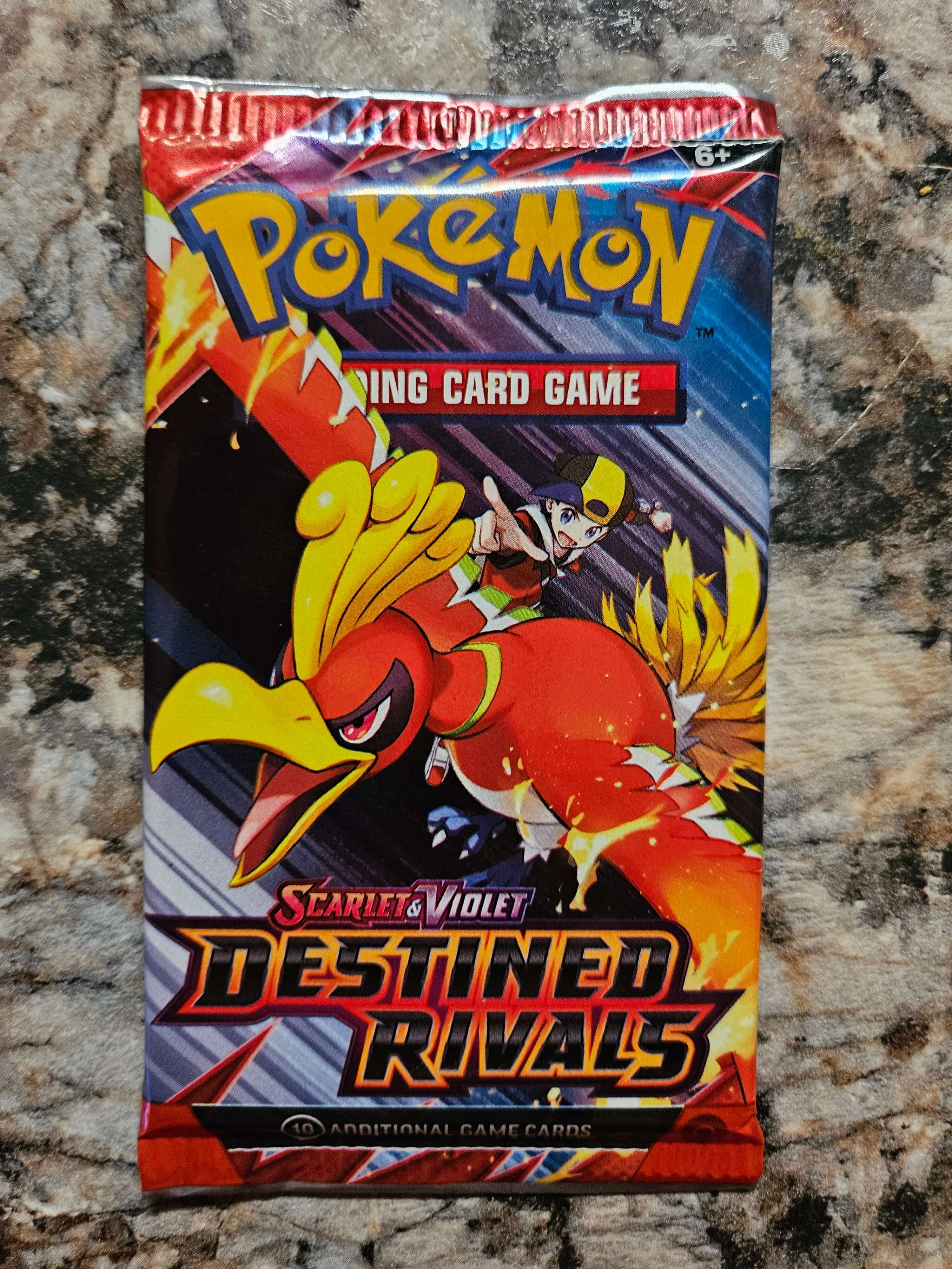 Pokemon Destined Rivals Booster Pack featuring Ho-Oh and new characters from the Scarlet and Violet series.