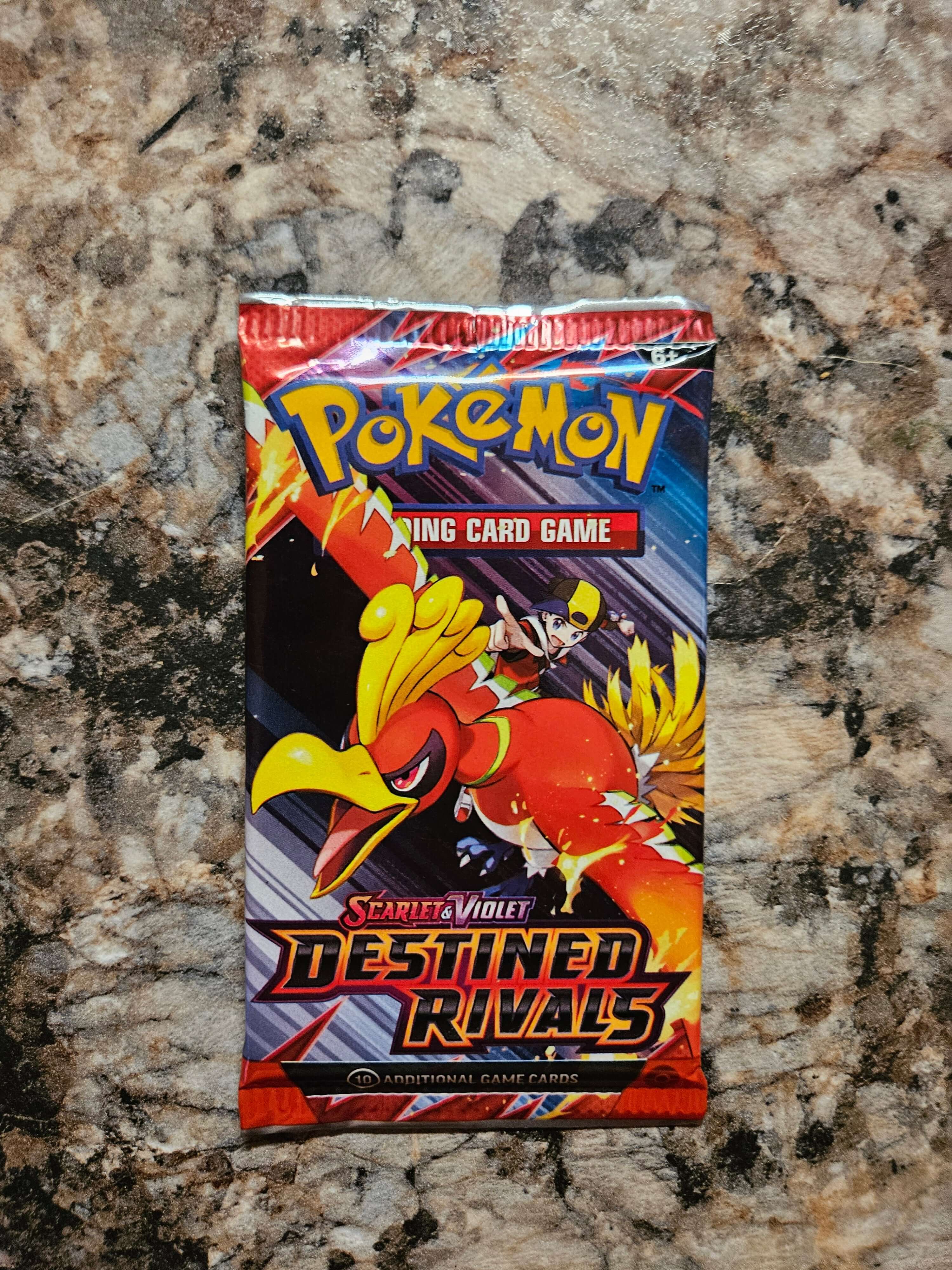 Pokemon Destined Rivals Booster Pack featuring Ho-Oh on colorful packaging.