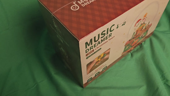 Rolife DIY Snow Globe Music Dreamer Christmas Town Edition with Santa Scene and Music Spheres packaging on green background.