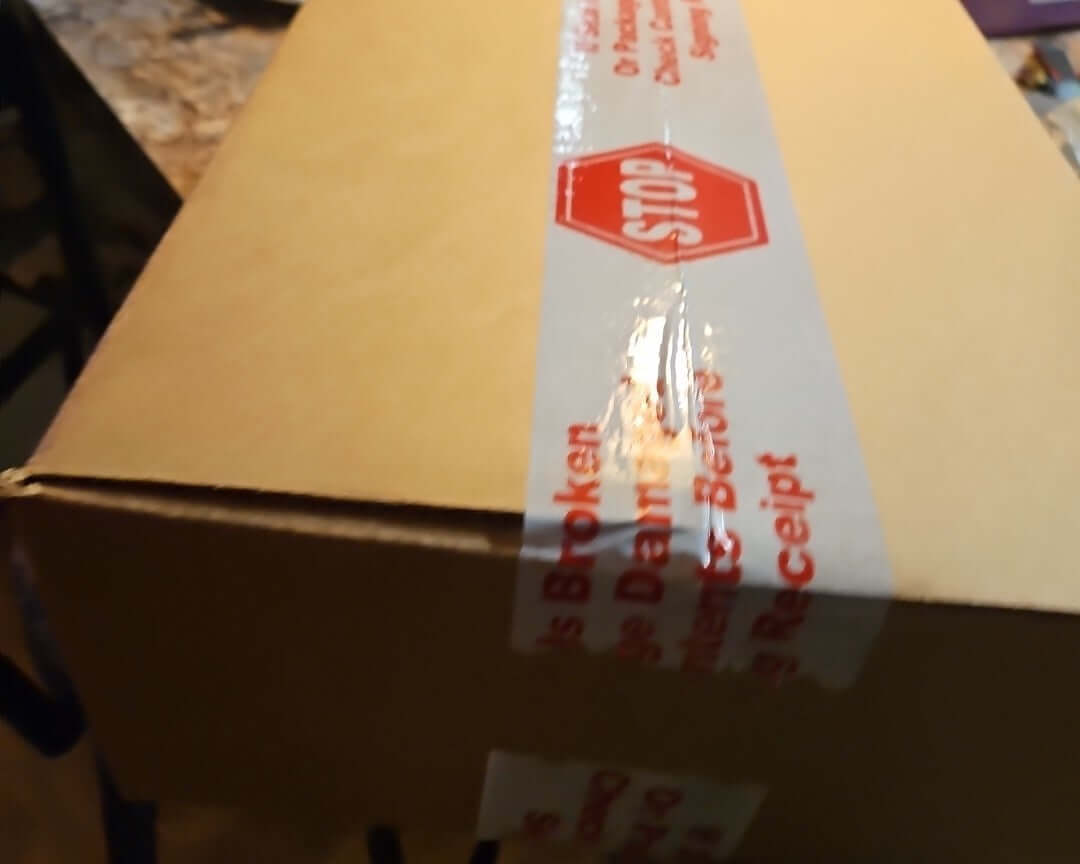 Destined Rivals Booster Bundle Sealed Case shipping box with caution tape warning.
